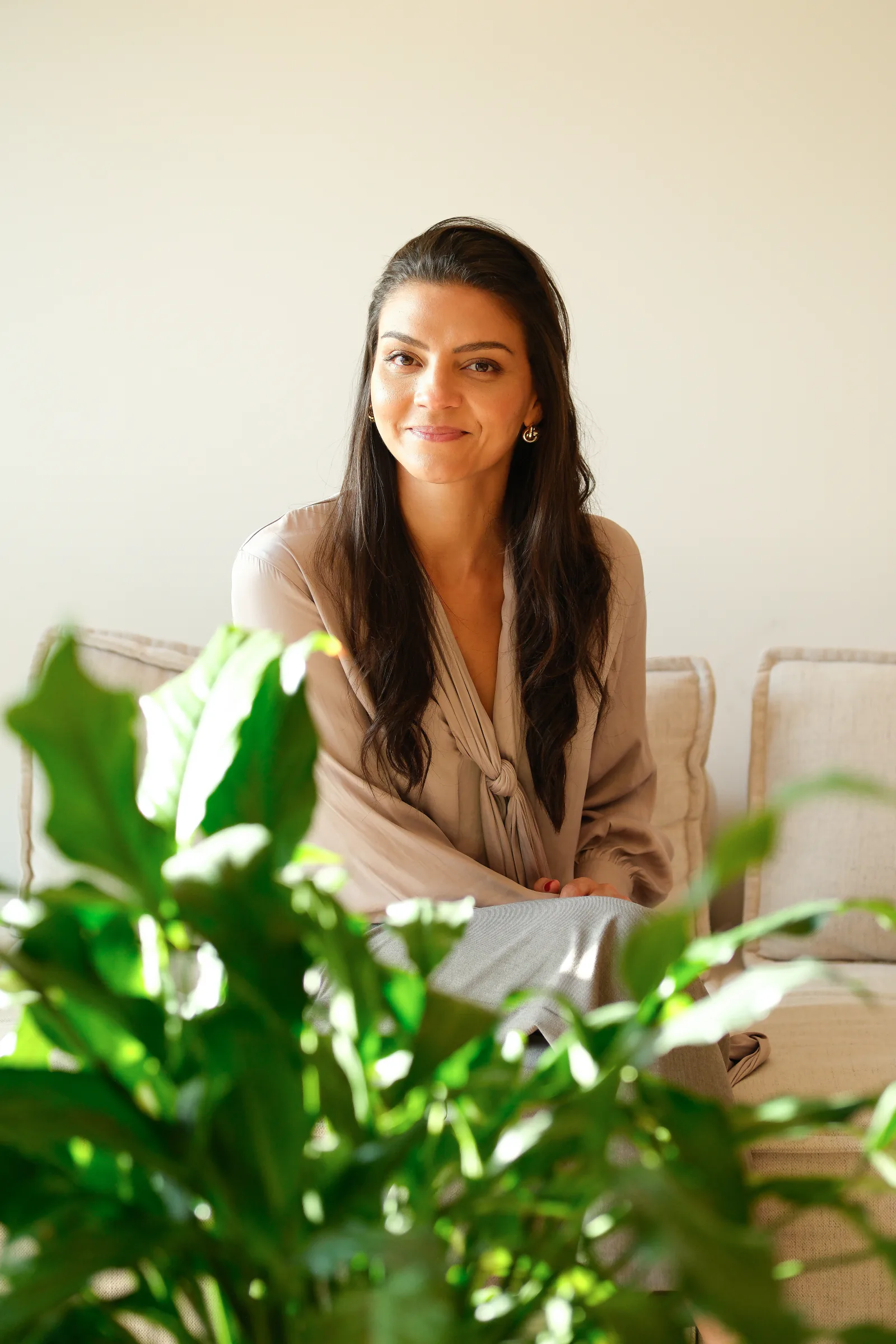 Bárbara sentada num sofá, num ambiente próximo e acolhedor